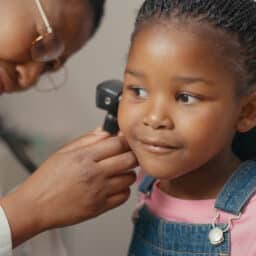 Young girl undergoing an ear exam.