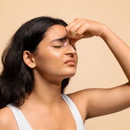 Woman holding her tender sinuses