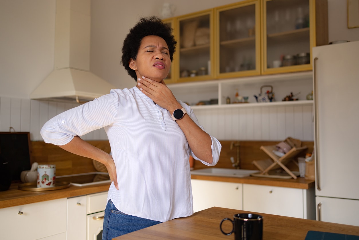 Woman with an uncomfortable feeling in her throat.